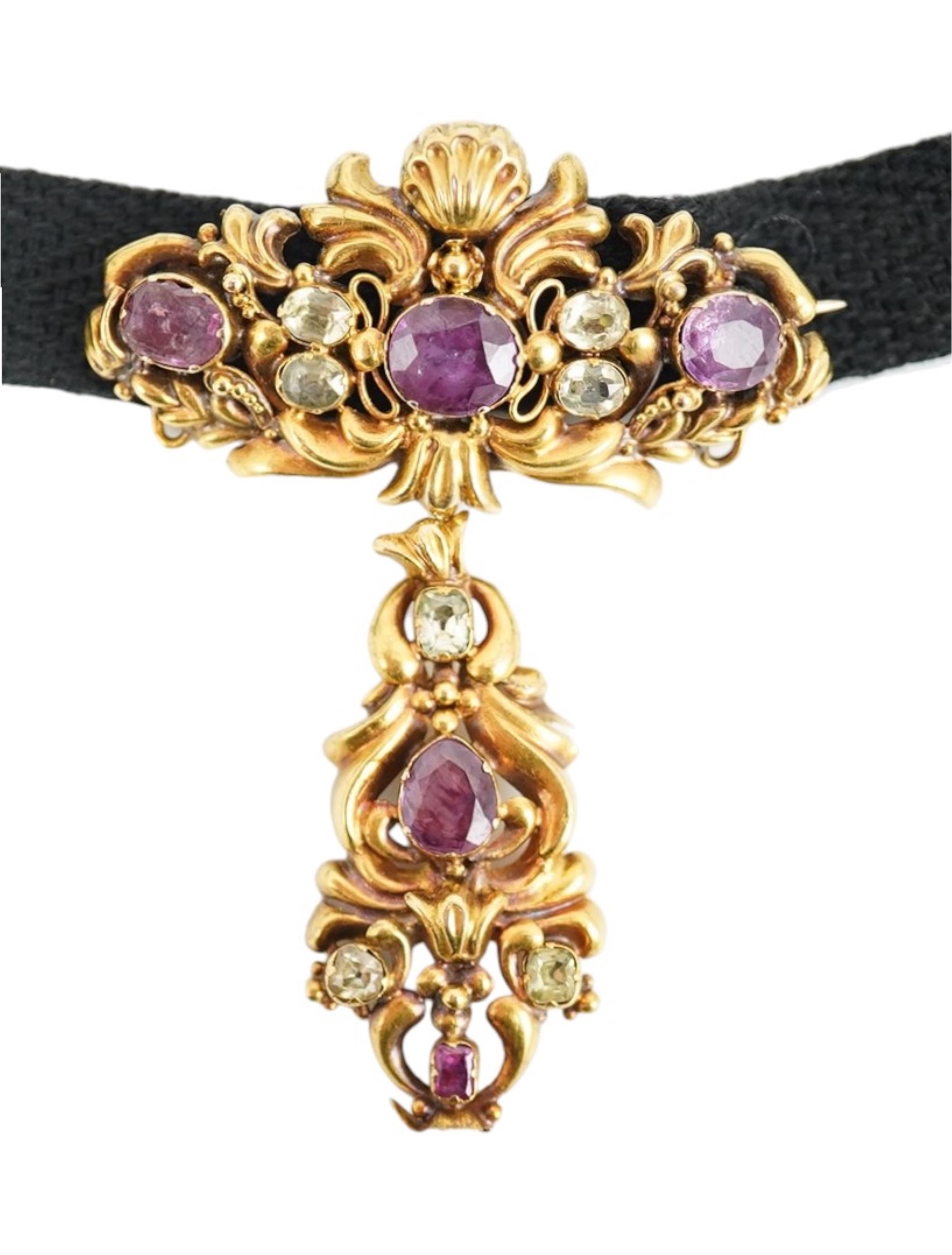 A Victorian yellow metal, garnet and chrysoberyl cluster set drop brooch, 56mm, on a black sash necklet